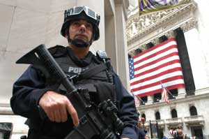 New York City police officers from Emergency Service Unit stand guard outside the New York Stock Exchange on Friday, Oct. 7, 2005. Threats to the city's mass transit system remained uncorroborated by evidence.