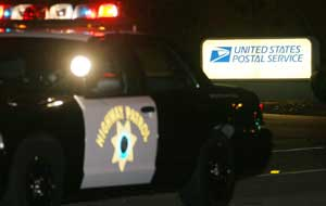 A California Highway Patrol vehicle blocks entry to a United States Postal Service mail facility in Goleta, Calif., Tuesday., Jan. 31, 2006 following a fatal shooting of six postal employees Monday inside the facility, before shooting herself. The suspect