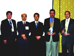 TOA Electronics leaders (left) present the awards to representatives from ASR Enterprises and NFS Communications during ISC West 2006.