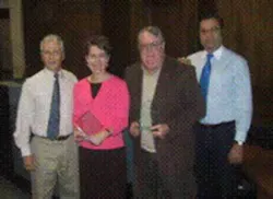Ron Haner of Alarm Center Inc. (left) and Jon Sargent of ADT (right) join Laura Wohl and Dick Machlan of the Olympia Police Department during the award presentation ceremony. Ron Haner of Alarm Center Inc. (left) and Jon Sargent of ADT (right) join Laura Wohl and Dick Machlan of the Olympia Police Department during the award presentation ceremony.