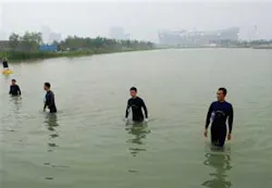 Frogmen wade out of the body of water after a security check near National Stadium, also known as Bird's Nest, background, in Beijing, Thursday, Aug. 7, 2008, a day before the opening ceremony of the Beijing 2008 Olympics. Frogmen wade out of the body of water after a security check near National Stadium, also known as Bird's Nest, background, in Beijing, Thursday, Aug. 7, 2008, a day before the opening ceremony of the Beijing 2008 Olympics.