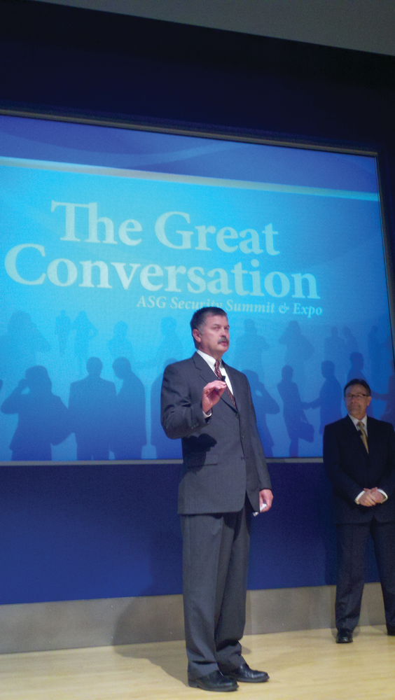 ASG's Phil Aronson (foreground) welcomes the crowd along with The Sage Group's Ron Worman (right).