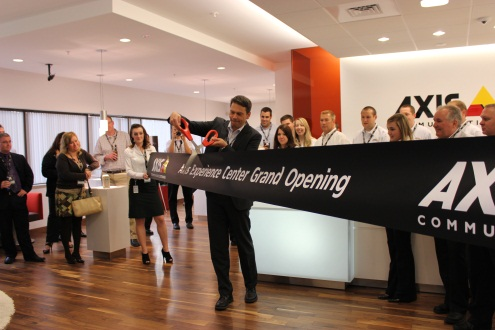 Axis General Manager Fredrik Nilsson cuts the ribbon at the company's new North American headquarters.