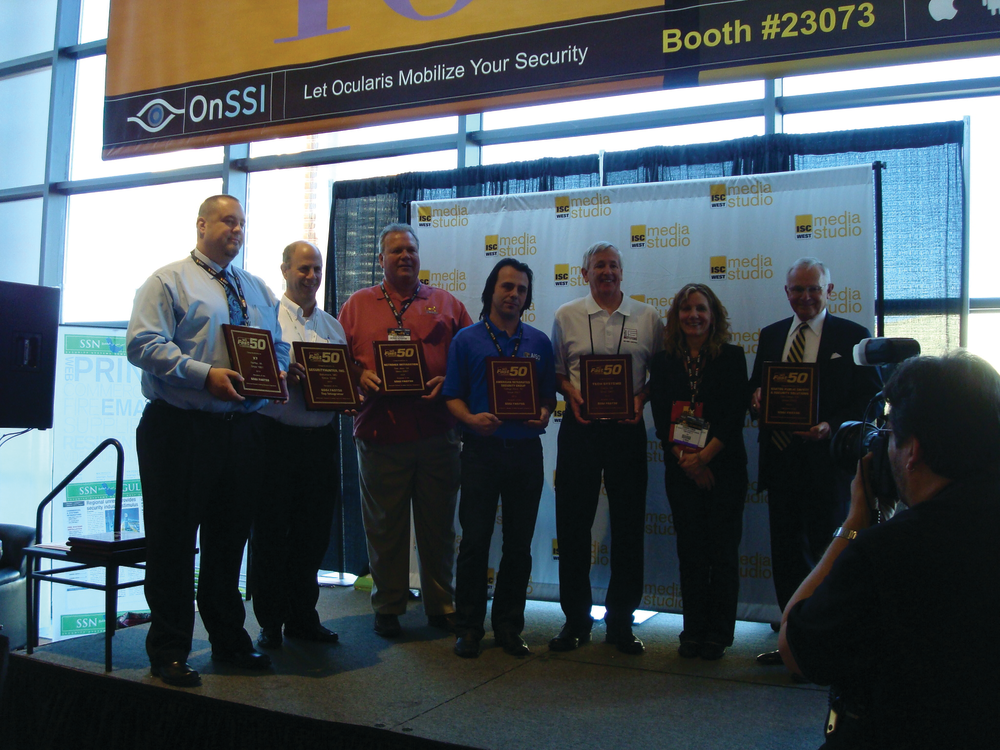 (L to R) Fast50 companies, X7; Securityhunter; Netronix Integration; American Integrated Security Group; Tech Systems; SD&I Editor O'Mara; and Kratos Public Safety & Security with accolades at ISC West 2013.