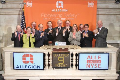 Allegion Chariman, President and CEO Dave Petratis (center) rings the opening bell at the New York Stock Exchange on Monday with other company executives.