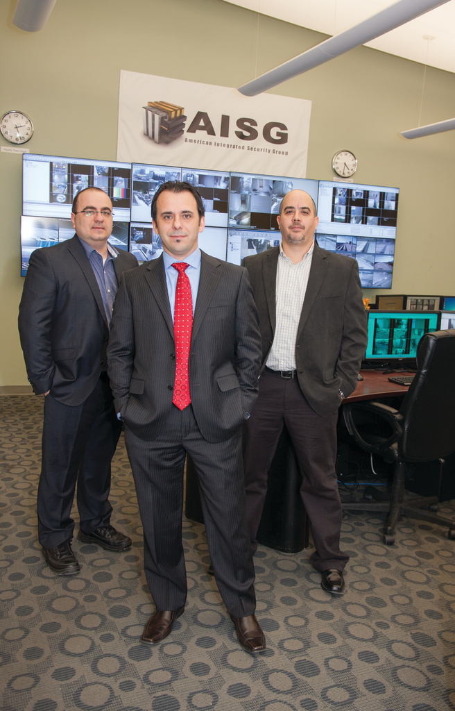 AISG President and CTO Levi Acs (front) is flanked by Arnold Koble, VP engineering (left) and Rocco Lipari, national operations director (right), inside the company's central monitoring facility.