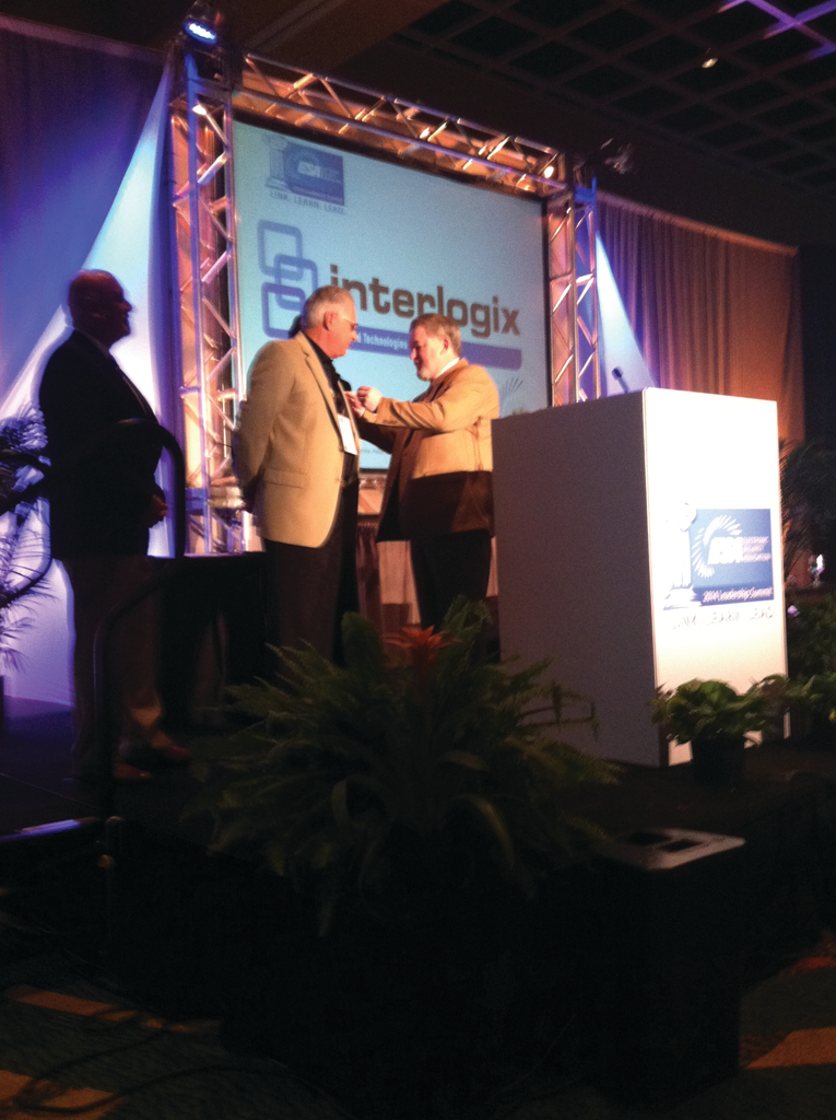 Weinstock Person of the Year recipient Charles Dom D&rsquo;Ascoli (left) receives a pin from 2013 winner David Koenig.