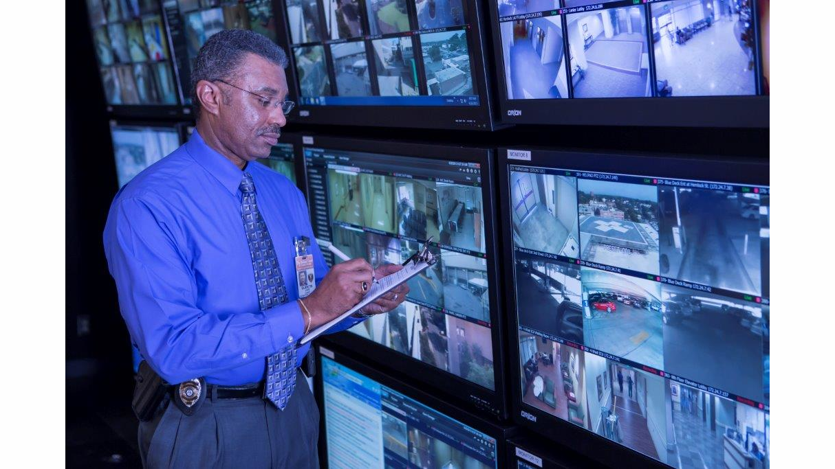 Navicent Police Chief Quentin Jude takes notes as he assesse real-time video surveillance in the command center.