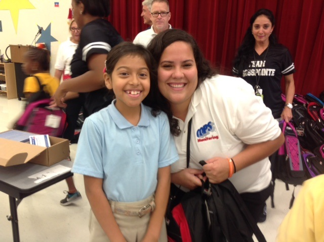 COPS Monitoring's Alejandra Hernandez with elementary school children at the kit build.