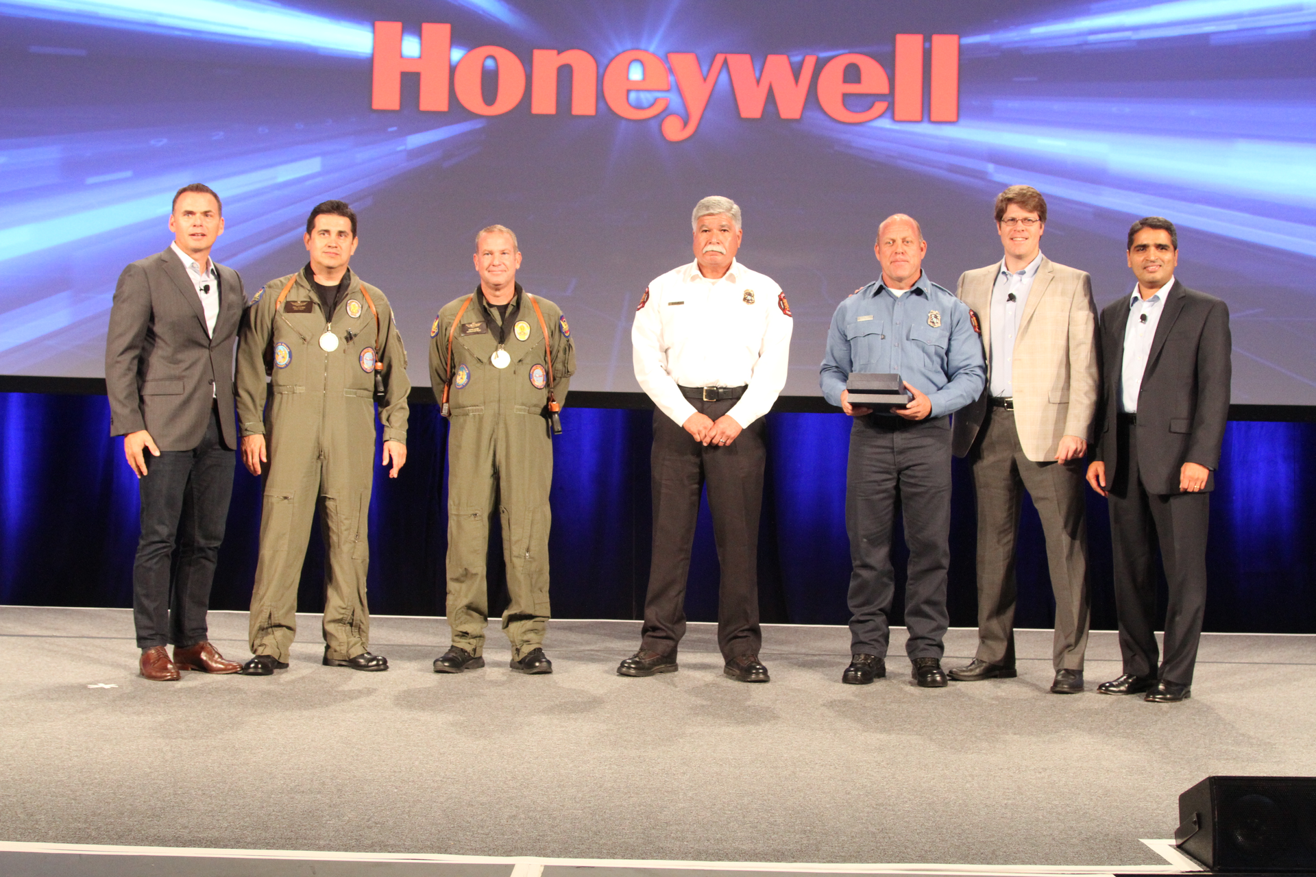 Members of the Phoenix Fire and Police Department who helped save two lives in an extreme flood rescue were honored by Marek Robinson (far left), President of Honeywell Authorized Dealer Programs.