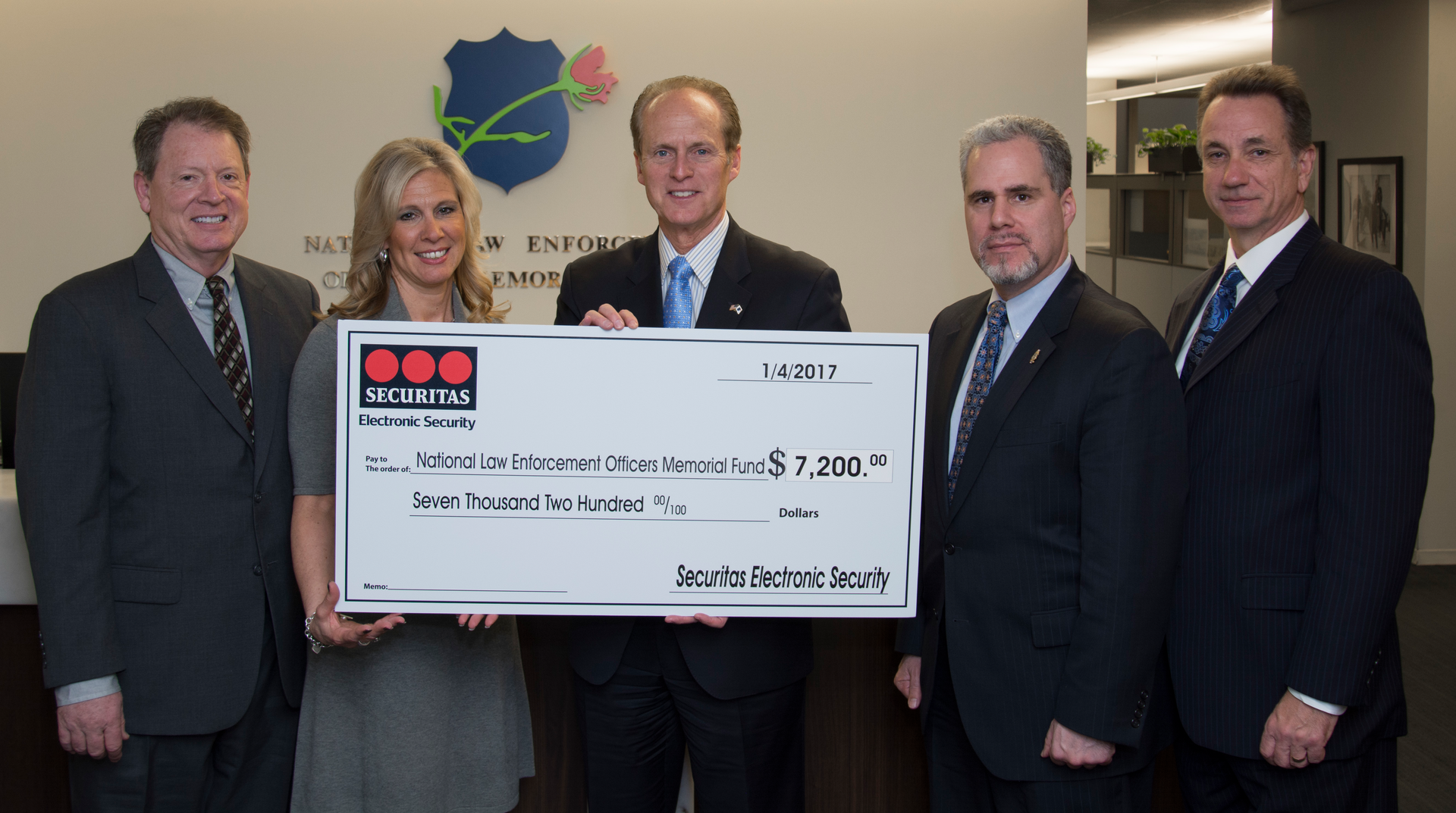 Securitas ES donated $7,200 to the National Law Enforcement Officers Memorial Fund as part of a booth promotion at ASIS. (L-R) Tom Nichols - Vice President Service Operations, SES; Terrie Ipson - Director, Marketing, SES; Craig Floyd - President & CEO, NLEOMF; Jon Adler - Vice Chairman, NLEOMF; James Osgood - Treasurer, NLEOMF.