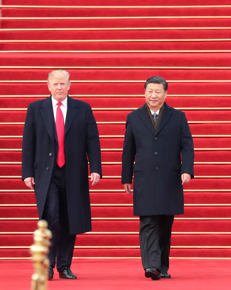 Chinese President Xi Jinping, right, holds a grand ceremony to welcome U.S. President Donald Trump at the square outside the east gate of the Great Hall of the People in Beijing, capital of China, Nov. 9, 2017.