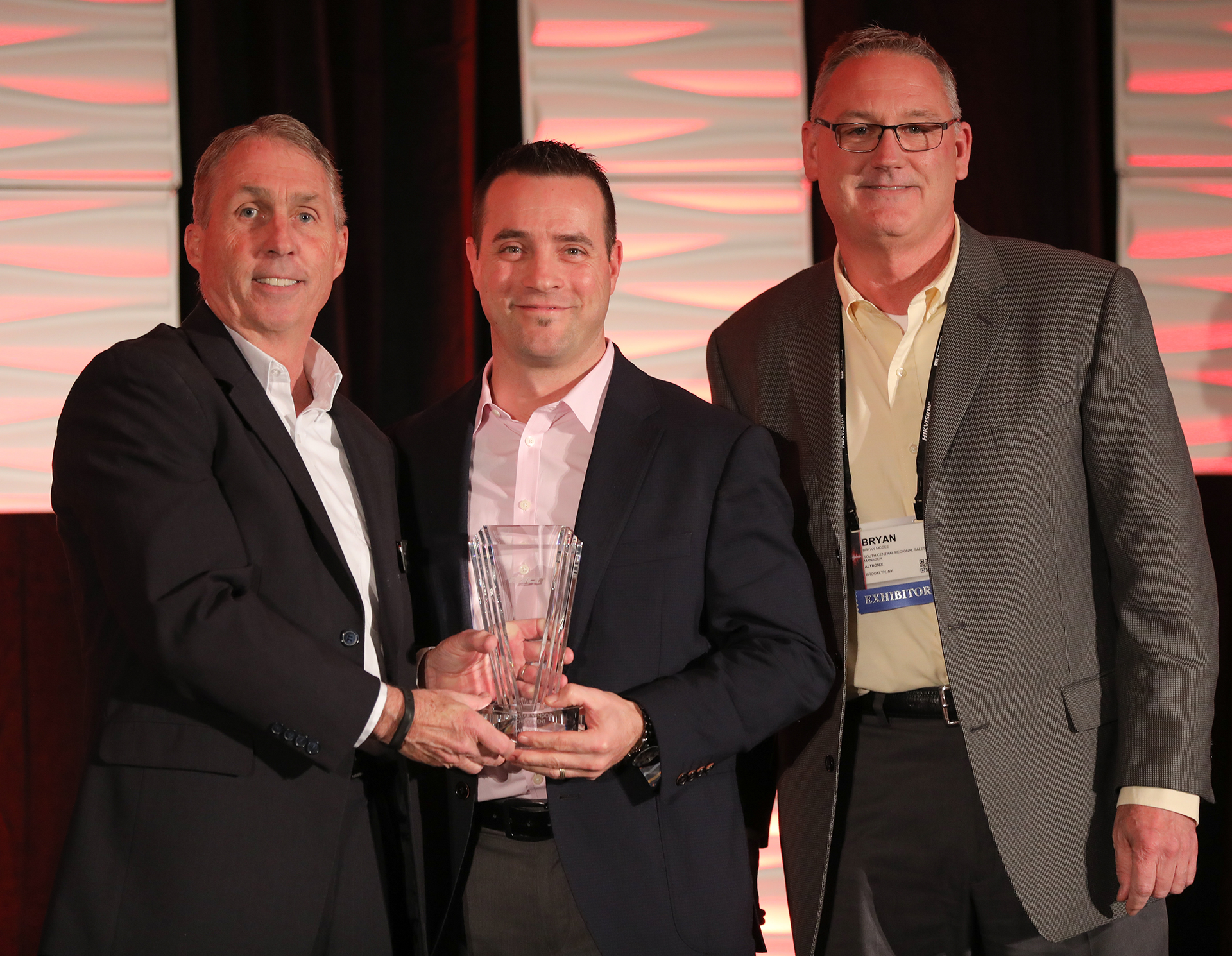 JR Andrews and Bryan McGee of Altronix (right) accept the Superstar Award from PSA&rsquo;s Craig Patterson.