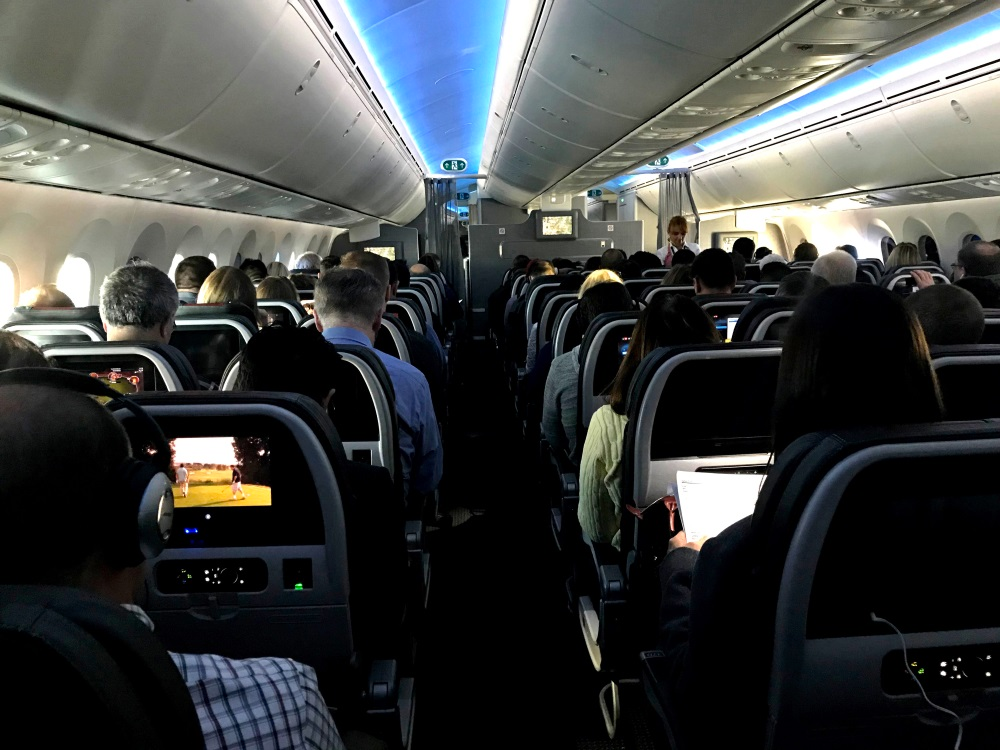 Main cabin passengers pass the time aboard American Airlines flight 2331, a Boeing 787-800 Dreamliner, an route from Chicago O'Hare International Airport to Dallas/Fort Worth International Airport, on March 5, 2018.