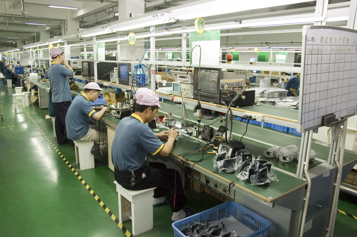 Workers test video surveillance components inside a manufacturing facility in Shenzhen, China, in April 2010. Legislation recently passed by the U.S. House would bar the FCC from reviewing or granting new equipment authorizations to companies on the agency's 'Covered List.'