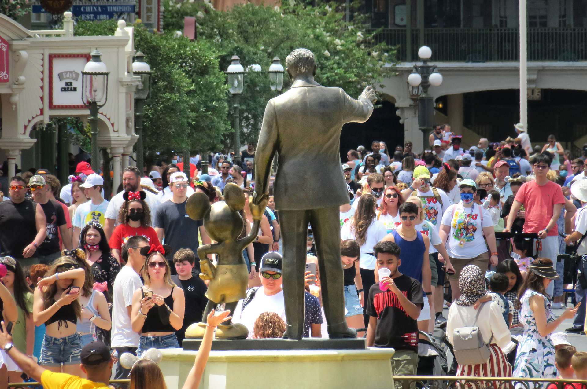 Guests congregate at the 'Partners' statue in front of Cinderella Castle at the Magic Kingdom at Walt Disney World, in Lake Buena Vista, Florida, on May 17, 2021. Magic Kingdom is among the U.S. theme parks that have been marred by fights among visitors recently.