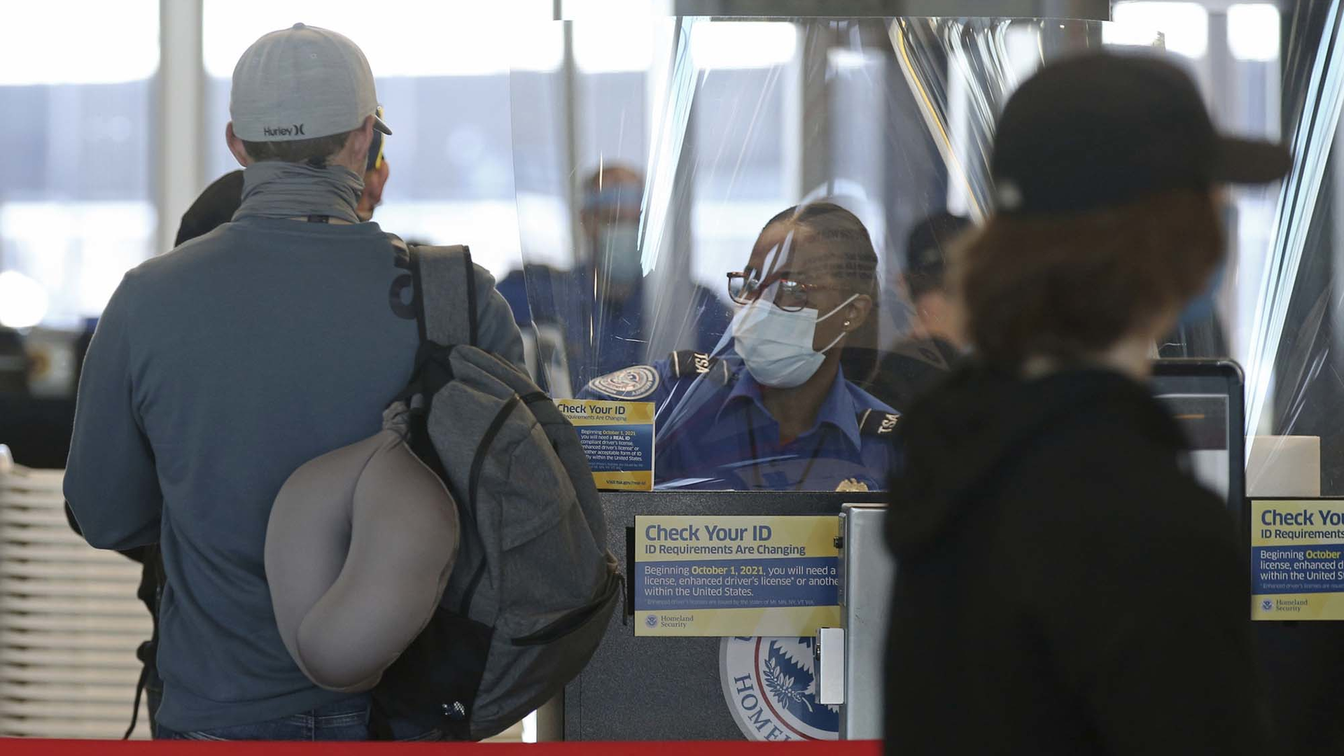 A Transportation Security Administration agent works at the security check area inside Terminal 3 at O'Hare International Airport on Nov. 12, 2020, in Chicago.