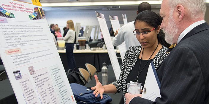 Eugene Spafford, director emeritus of CERIAS and professor of computer science, attends the 2022 poster session of the 23rd Annual CERIAS symposium.