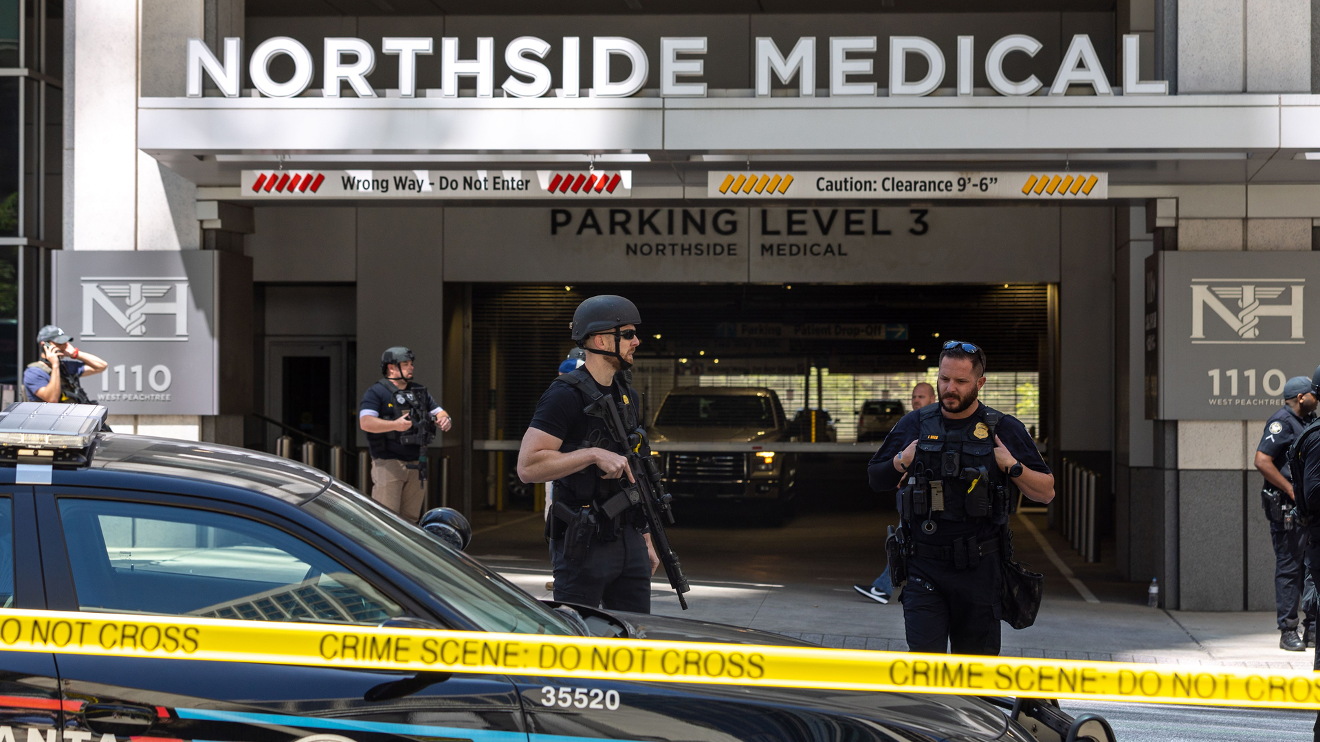 Law enforcement officers are seen on West Peachtree Street in front of Northside Hospital Midtown medical office building, where five people were shot on May 3, 2023.