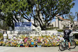 LAGUNA WOODS, CA - MAY 22: Warren Bidmead of Laguna Beach stops at the sidewalk memorial in front of the Geneva Presbyterian Church in Laguna Woods on Sunday, May 22, 2022. He said he rode past this location an hour before the shooting at the Irvine Taiwanese Presbyterian Church a week earlier. He said he couldn't imagine the horror of being together in church and this happening. LAGUNA WOODS, CA - MAY 22: Warren Bidmead of Laguna Beach stops at the sidewalk memorial in front of the Geneva Presbyterian Church in Laguna Woods on Sunday, May 22, 2022. He said he rode past this location an hour before the shooting at the Irvine Taiwanese Presbyterian Church a week earlier. He said he couldn't imagine the horror of being together in church and this happening.