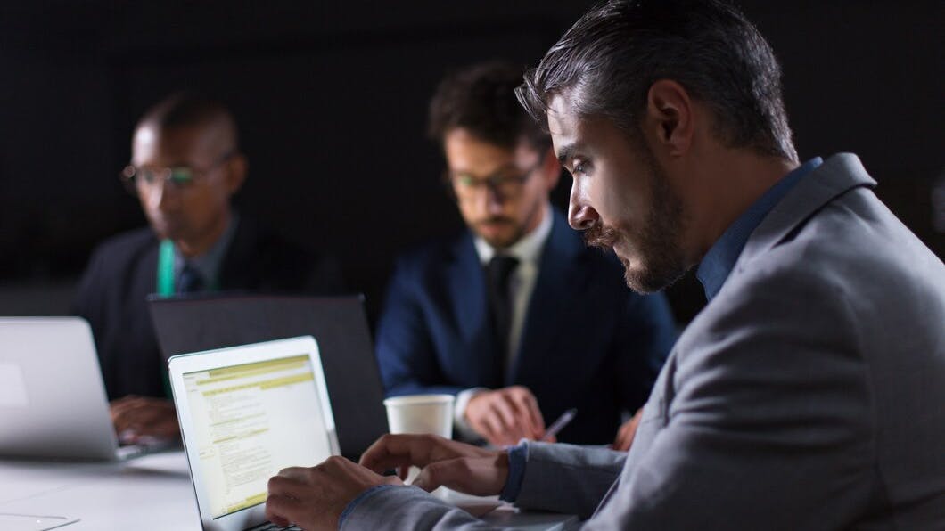 6700110e3b3d966557a8b804 Focusedmantypinglaptopwhileworkingofficenight 7485