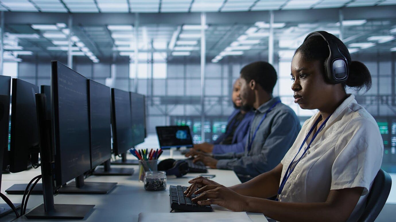 67fff0f6ece0523d48feb1be Portraitsmilingengineerwearingheadphonesdatacenter