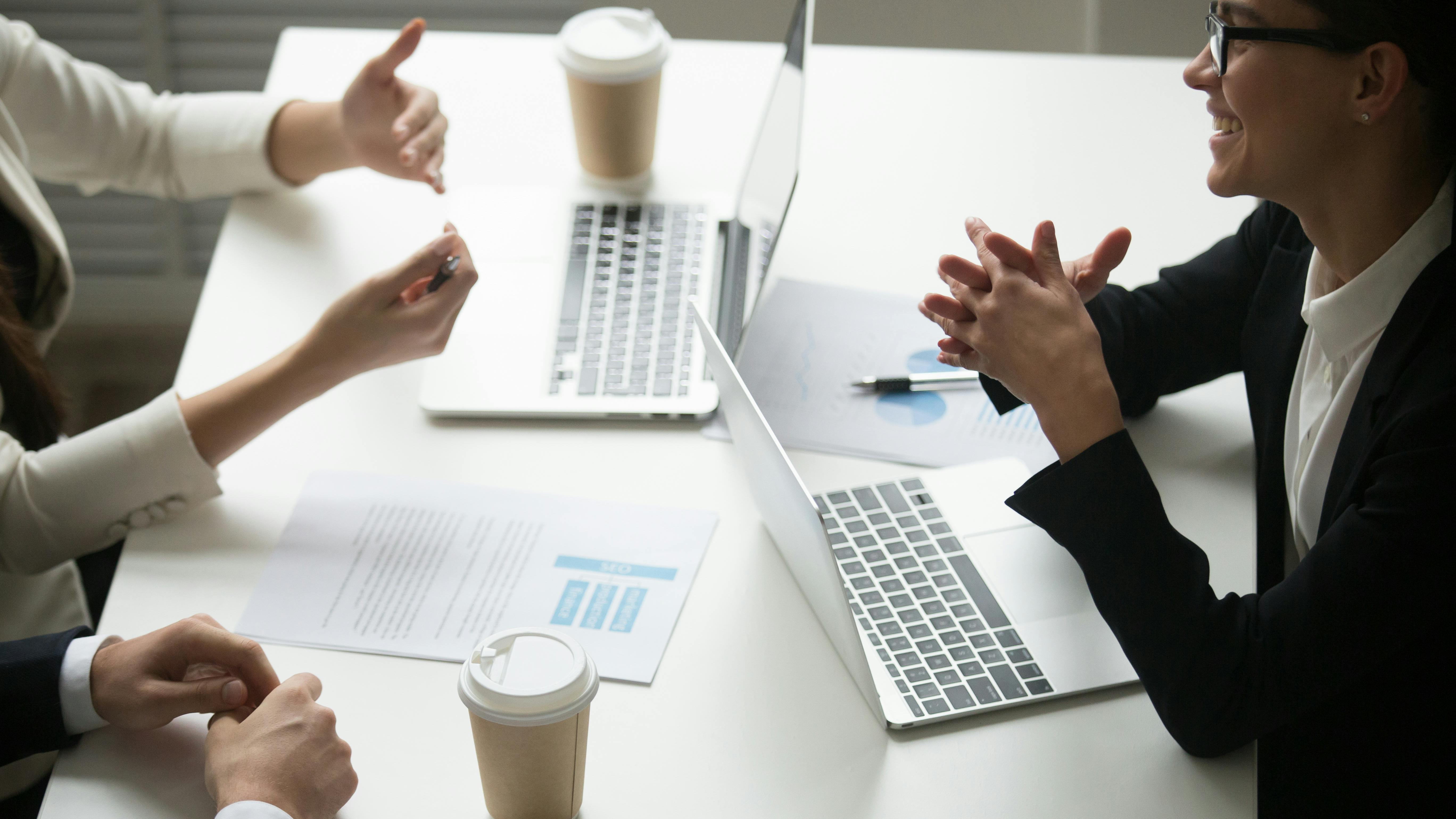 682f4c8e7aa9222cd85ff2d4 Smilingbusinesswomanenjoyingtalkwithcolleaguesteam