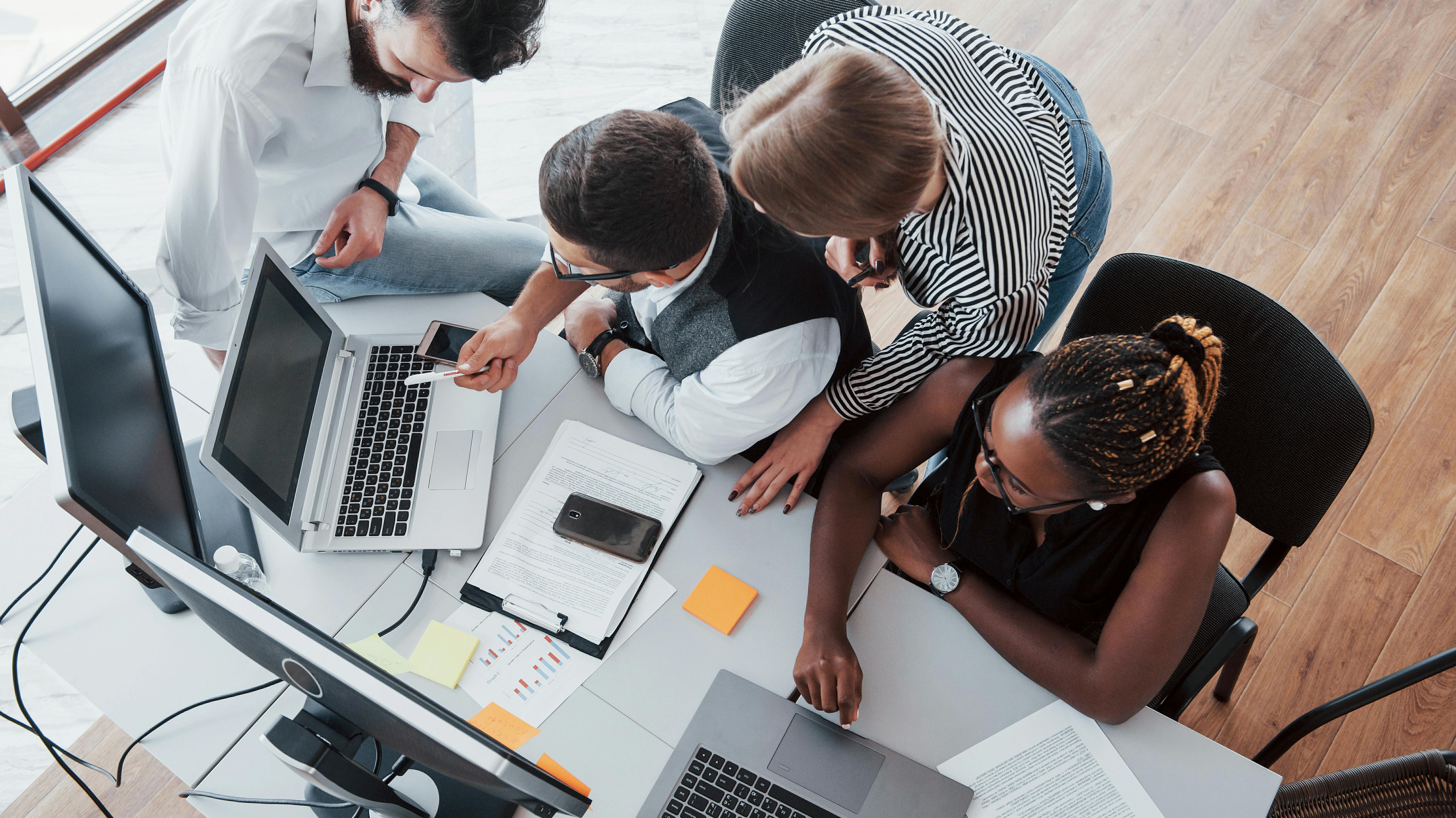 6859aa006bc0758c8597c2b9 Groupmultinationalbusypeopleworkingoffice