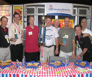 Representatives of ACE joined LHD Vending in honoring the winners of the company&rsquo;s hot dog eating contest, which took place on the show floor. At left are: Alan Plaisted, Southern Refreshment Services, Tucker, Ga., ACE representative; Darrell Sims, Southern Refreshment Services, representing Georgia, 4th place; John Fourqurean, Gallins Vending Service, Winston/Salem, N.C., representing North Carolina, 2nd place; Jason Mims, Coastal Vending & Food Service, Charleston, S.C., representing South Carolina, 1st place; Leon Leykin, LHD Vending; Geoff Cook, RE Services Inc., Chesapeake, Va., representing Virginia, 3rd place; John Trego, Coastal Vending & Food Service, ACE representative; and Greg Westnedge, LHD Vending.