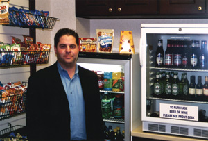 Aaron Speagle of Piedmont Vending Inc. checks on a Freedom Shopping kiosk.