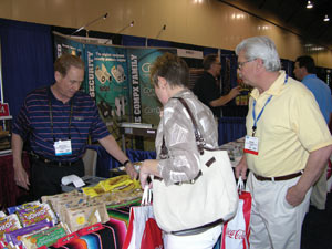 Mike Elliot, Don Miguel Mexican Foods Inc., left, shows Michelle and Don May, Total Coffee & Vending Services Inc., Livonia, Mich., the new breakfast empanadas.