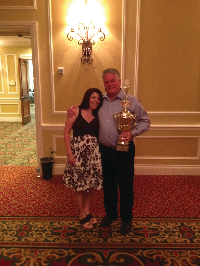 Melissa Johnson, Harold W. Young product brokerage, awards Steve Foley, Foley Food & Vending Inc. in Norwood, Mass., the Harry Wishart Award.