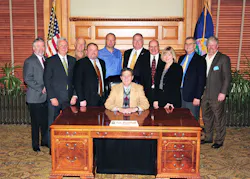 Kansas Governor Sam Brownback (center), surrounded by Mike Cox, John Barnes, Denny Burgess, Chip Stephenson, Joe Hemmelgarn, Claude Bockhold, Bill Bradford, Sandy Larson, Keith Bottorff and Tom Burgess. Kansas Governor Sam Brownback (center), surrounded by Mike Cox, John Barnes, Denny Burgess, Chip Stephenson, Joe Hemmelgarn, Claude Bockhold, Bill Bradford, Sandy Larson, Keith Bottorff and Tom Burgess.