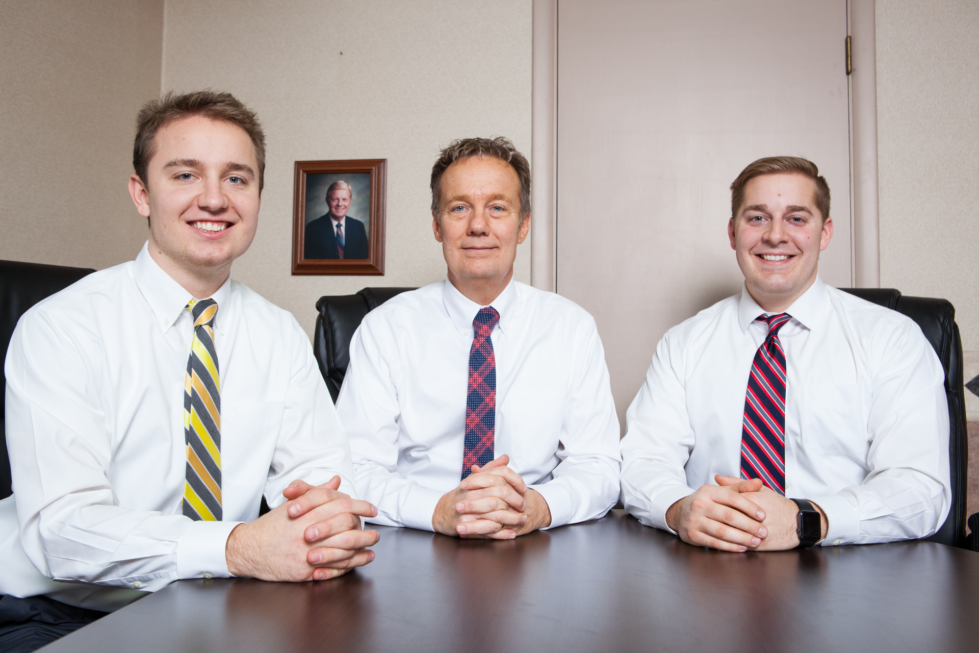 Three generations of Plassmans have worked at Maumee Valley Vending. Donald, pictured on the wall, his son Todd, center, and grandsons Jacob, left, and Jordan.