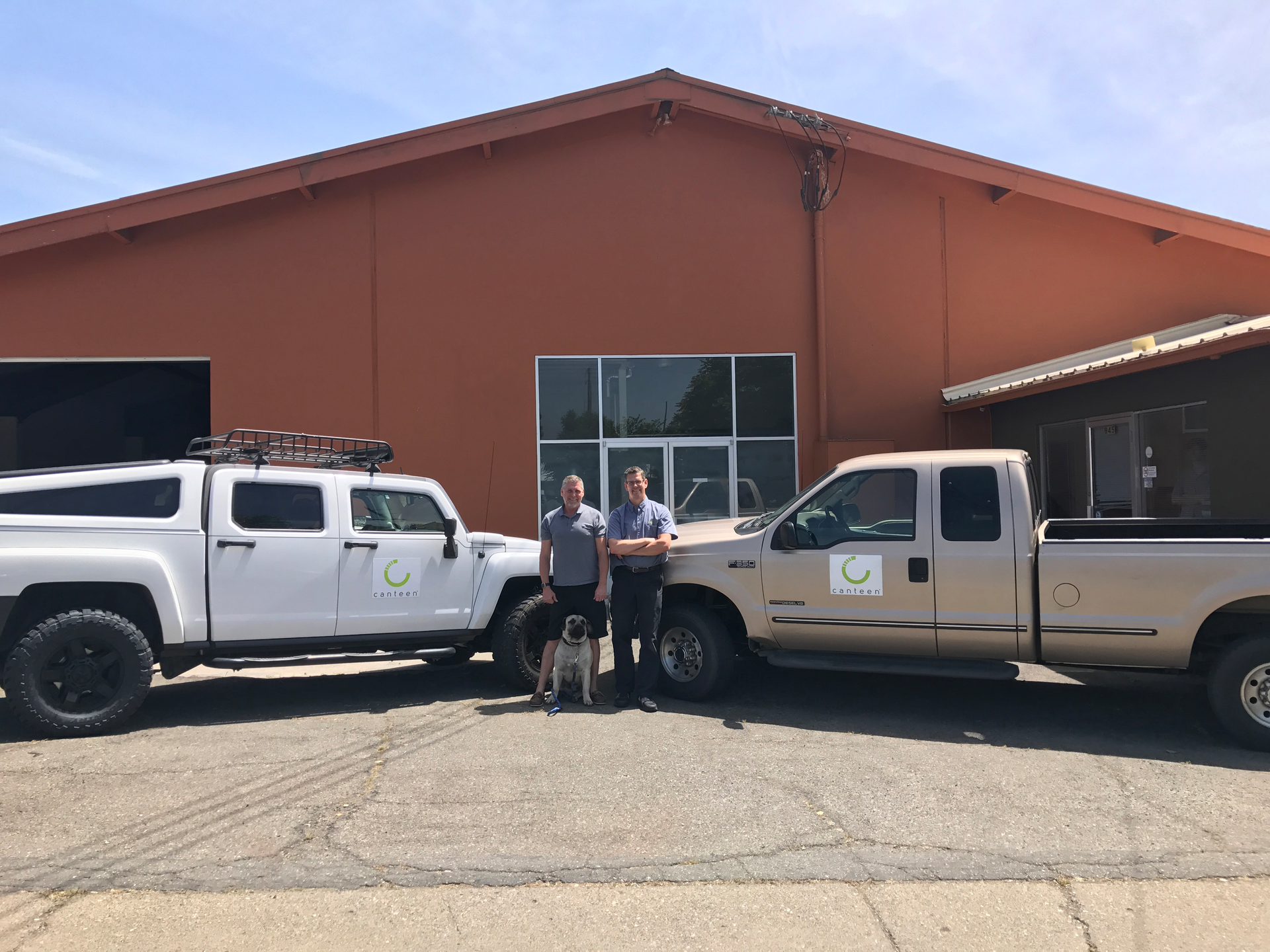 WeServ owner Todd White, left, relies heavily on Jeff Schmaljohann, general manager. The young pup Tito is training to be a guard dog.