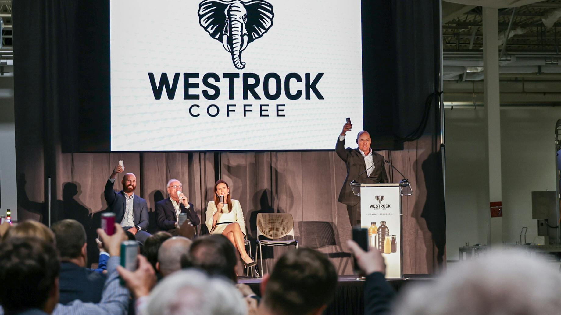 Scott Ford, co-founder and CEO of Westrock Coffee, raises a ready-to-drink can produced by Westrock Coffee to officially toast the grand opening of the company's RTD facility in Conway, Arkansas on June 13, 2024. From left, he is pictured with Will Ford, group president of operations; Joe T. Ford, co-founder and chairman; and Arkansas Gov. Sarah Huckabee Sanders.