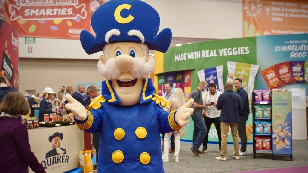 The Quaker mascot welcomes guests at the 2024 Sweet & Salty Expo.