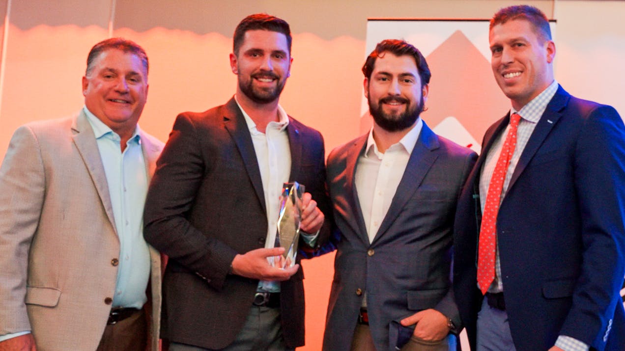 Members of the Sheehan Brothers Vending team, including company president Patrick Sheehan, center left, and company operations manager Michael Sheehan, center right, accept the 2025 Business of the Year award from the Greater Springfield Partnership.