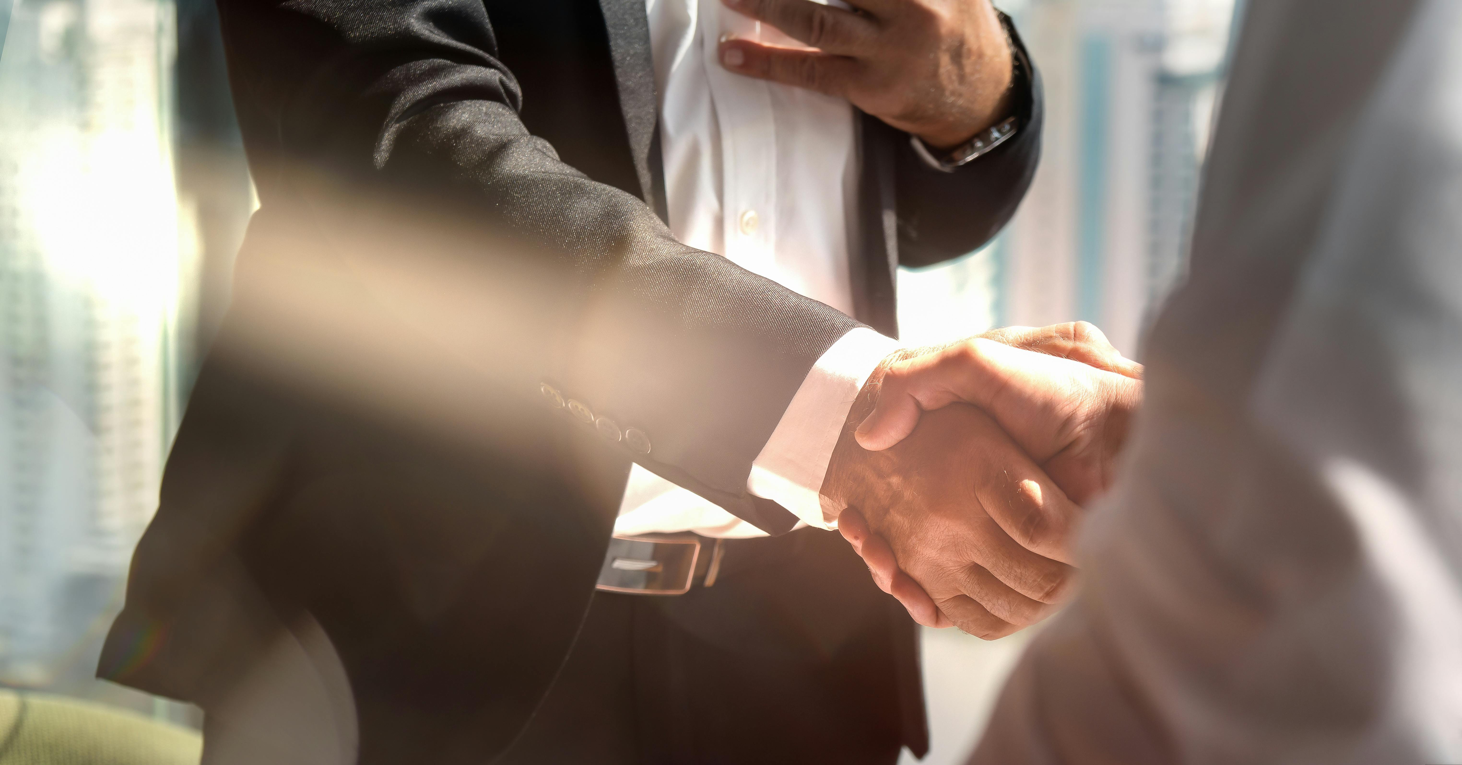 Businessman handshake for teamwork of business merger and acquisition. Business background of businessmen have handshaking in greeting of business deal of merger and acquisition agreement.