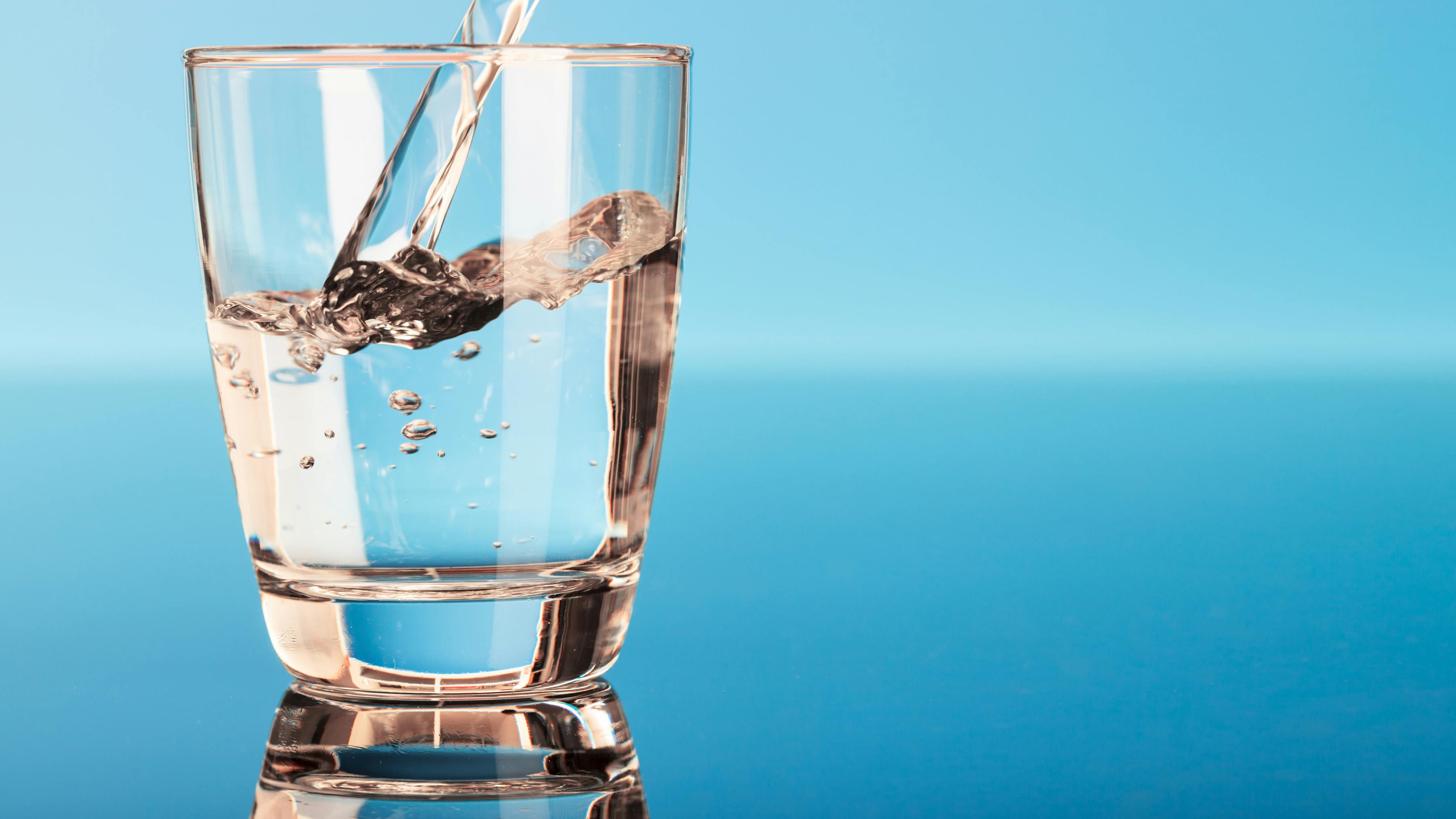 Drinking water is poured into a glass