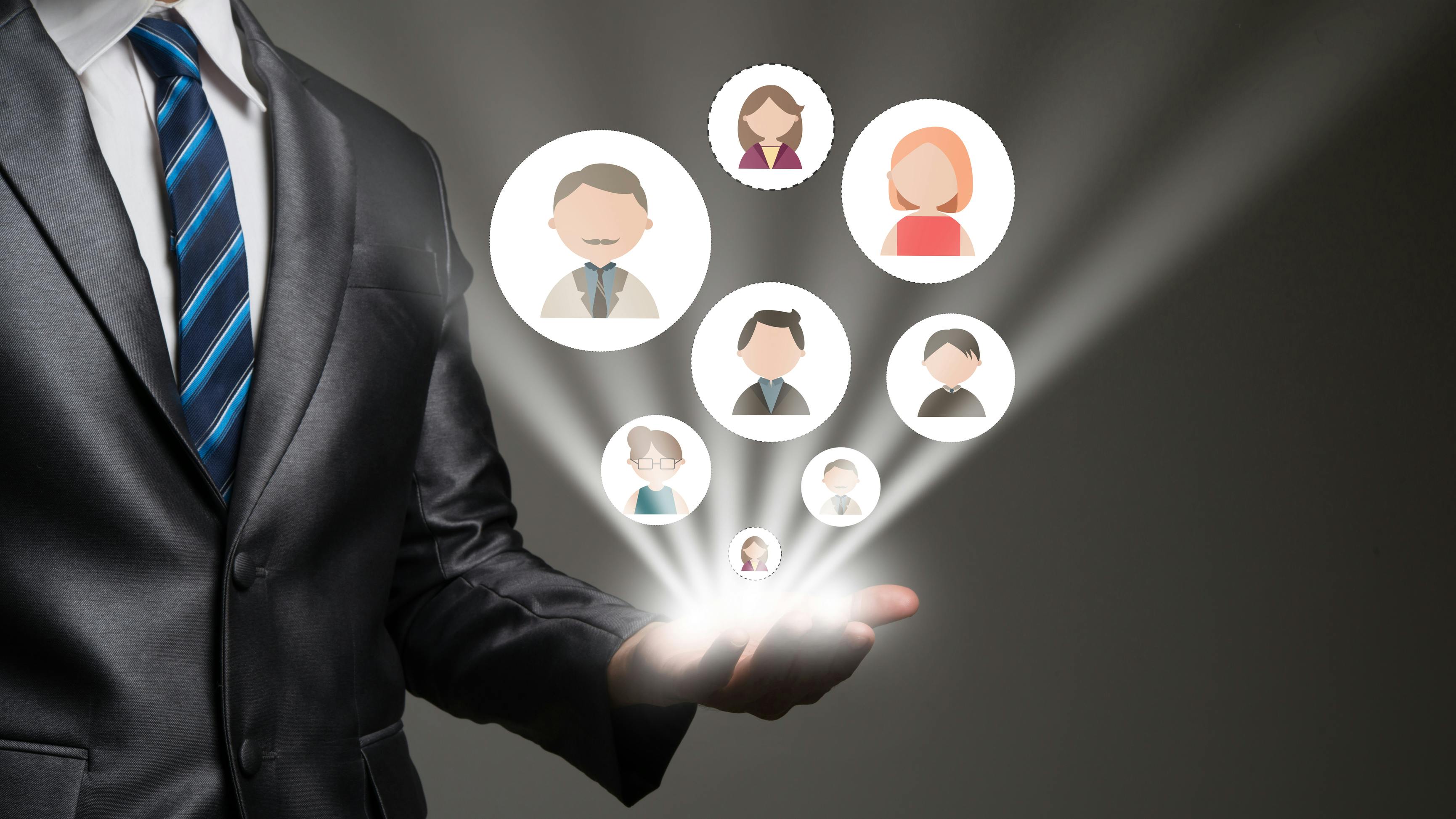 Businessman pointing digital peopl network connection icons on his hand.