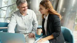 Two professionals in a contemporary office break area having a relaxed conversation, coffee cups in hand, Two professionals in a contemporary office break area having a relaxed conversation, coffee cups in hand,