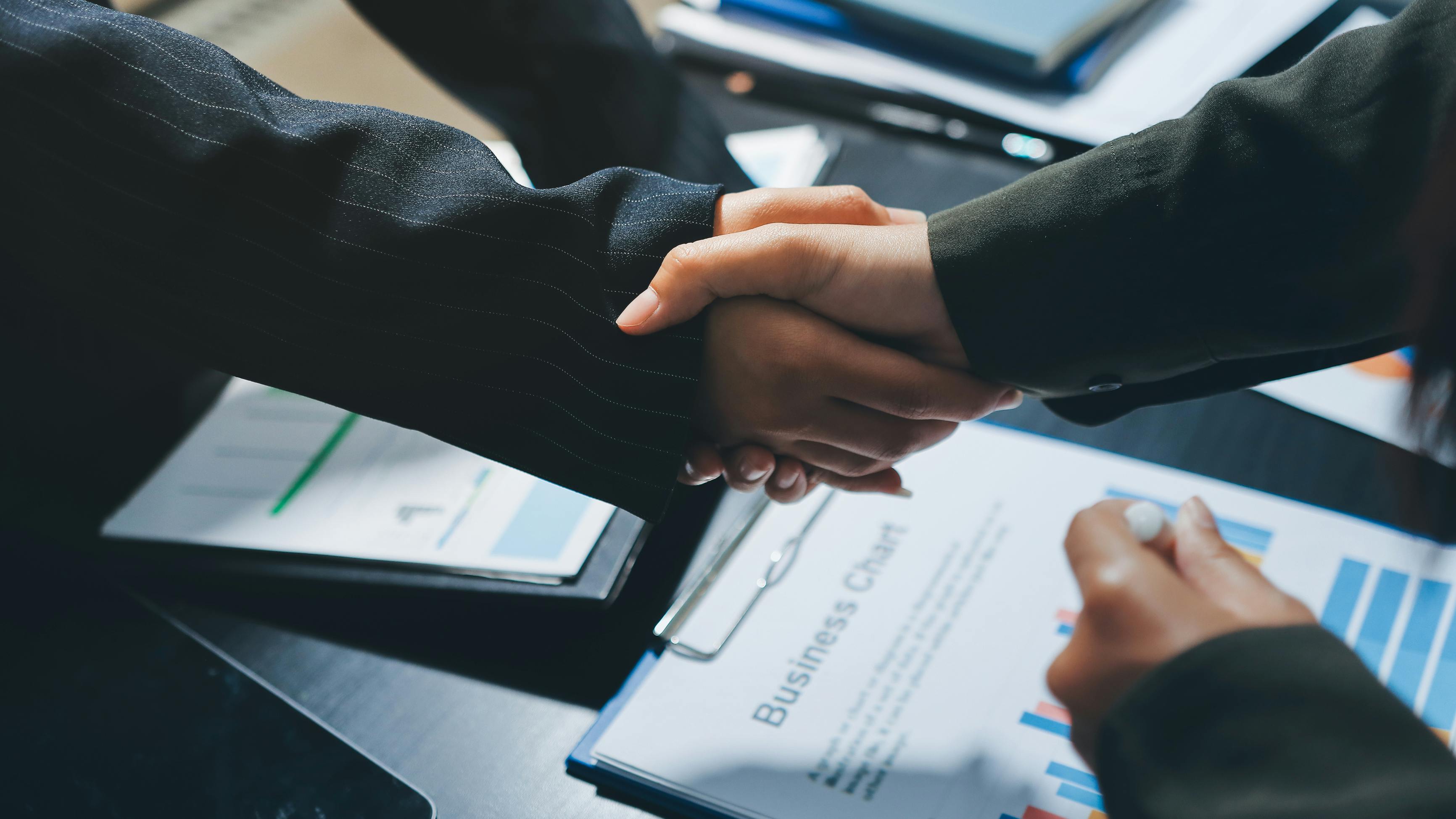 handshake across a desk