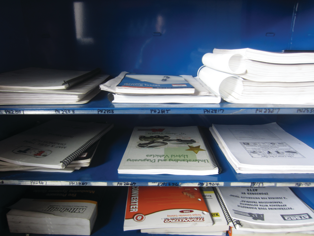 Figure 7: The more information, the better. Here paper manuals are organized for quick reference. Among the more popular paper manuals are Mitchell 1's TPMS reset quick-reference manual and Autodata's manuals on relearns and other procedures, both visible in this picture.