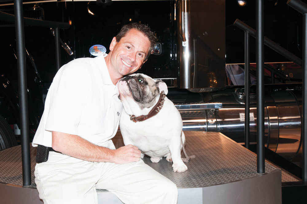 2012 Walk the Bulldog champion Fred Schmidt celebrates his victory with Mack the Bulldog.