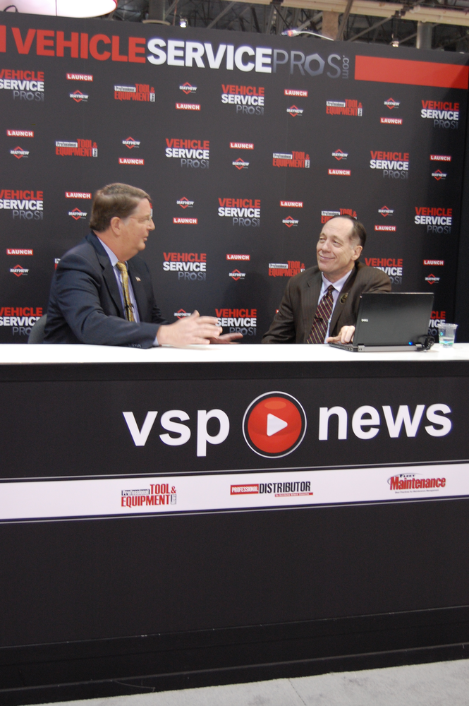 AAIA's Scott Luckett, left, talks about the AAIA Telematics Challenge during a live streaming segment at AAPEX 2012.