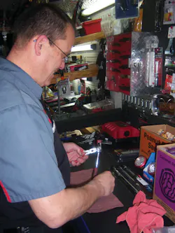 Wayne Kolvoord adjusts a ratchet on his truck. Wayne Kolvoord adjusts a ratchet on his truck.