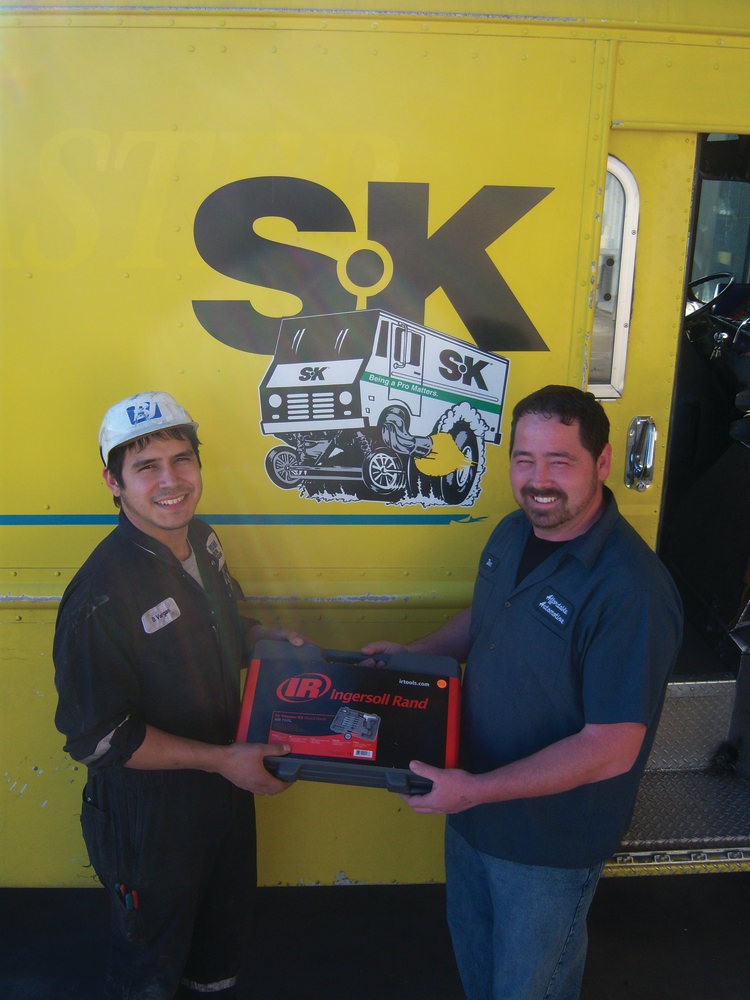 Clint Maxwell, right, gives an Ingersoll Rand air hammer to a customer at a shop that services oil tankers.
