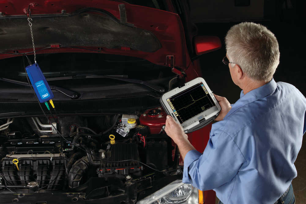 Figure 3A: Here, a technician is hooked up with a labscope to an ignition coil, by back probing its ground with an OTC Tech Scope, No. 3857. For more information on this product check out www.VehicleServicePros.com/10615029.