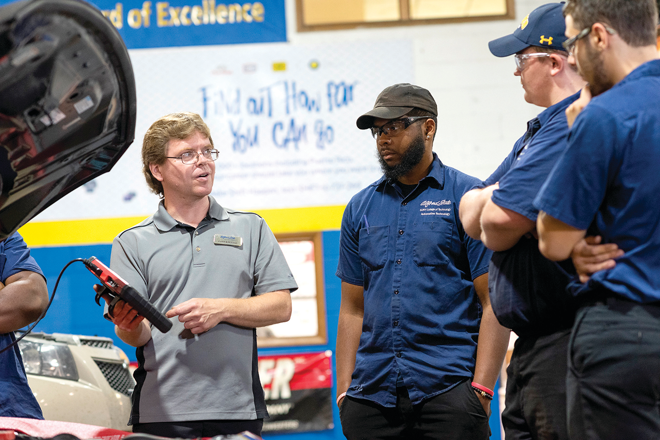 Alfred State College of Technology Instructor Jason Kellogg works with students in a recently rebranded &lsquo;Race to 2026&rsquo; technical training facility at the school.